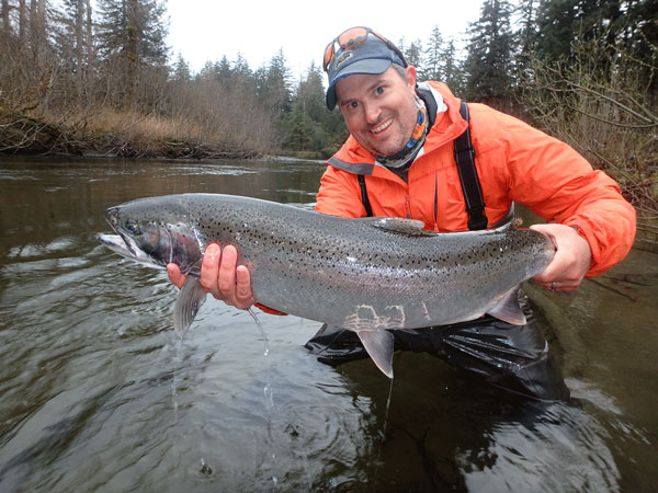Instructor Peter Westley holding a salmon he caught.